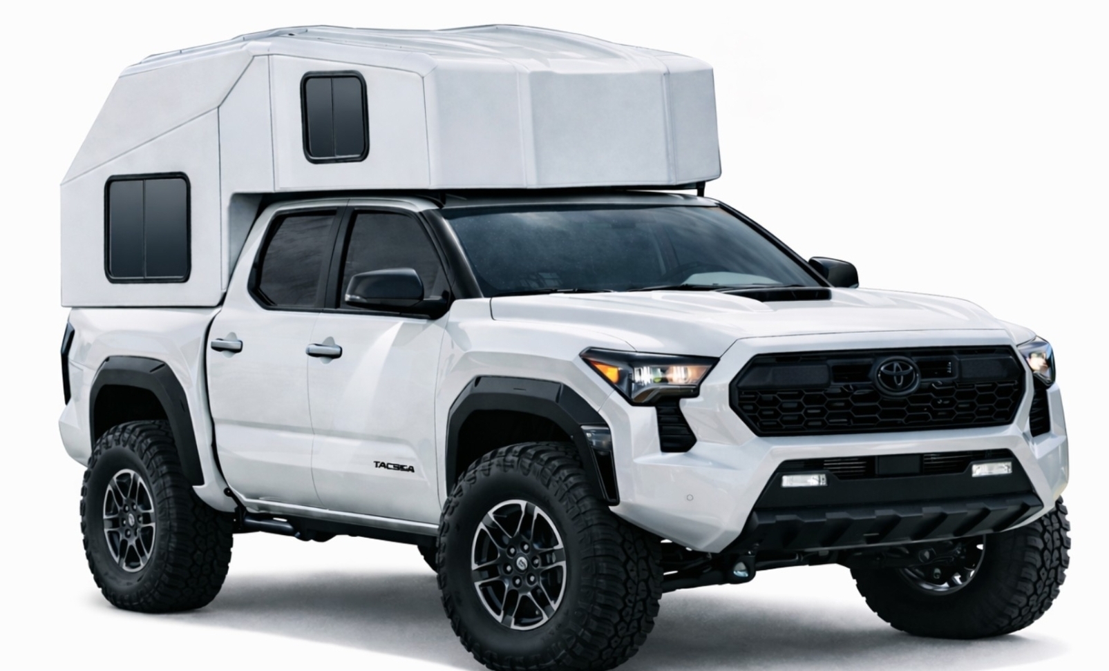 TacoHut composite camper with raised top shell mounted on a white Toyota Tacoma